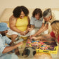 Group of people playing a puzzle together on a couch