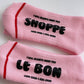 Pink socks with black text on a white background
