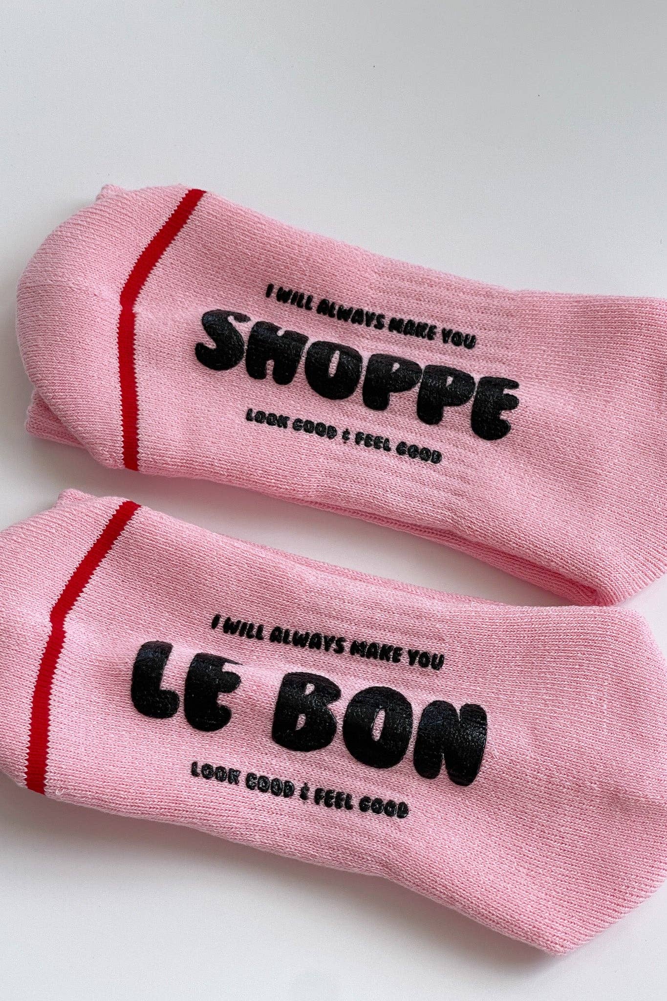 Pink socks with black text on a white background