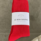 Red sock with a white label on a stone surface