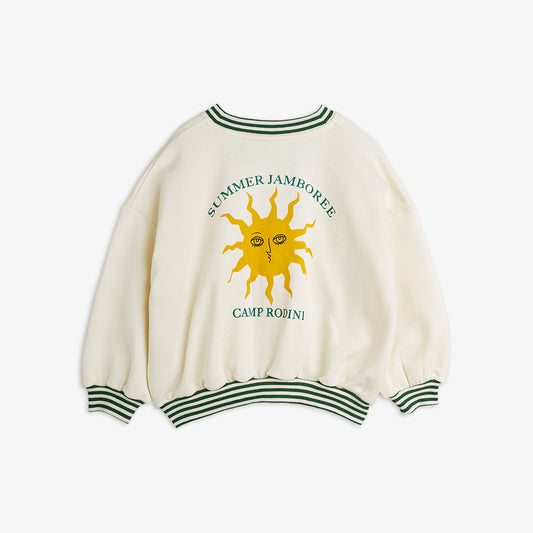 White sweater with sun design and text on a white background