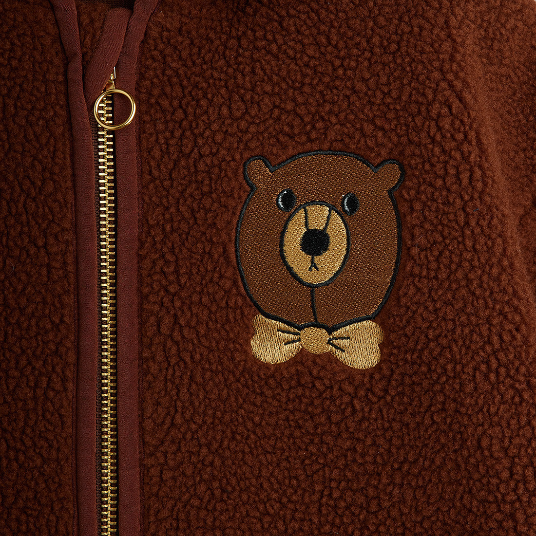 Brown fleece jacket with a teddy bear emblem and zipper
