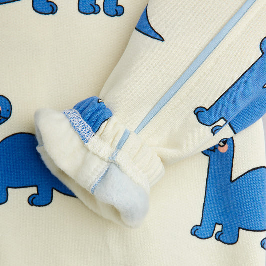 Close-up of baby shoes with blue bear pattern on cream fabric