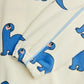 Close-up of a fabric with blue dinosaur prints on a white background