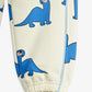 Children's pants with blue dinosaur pattern on a white background