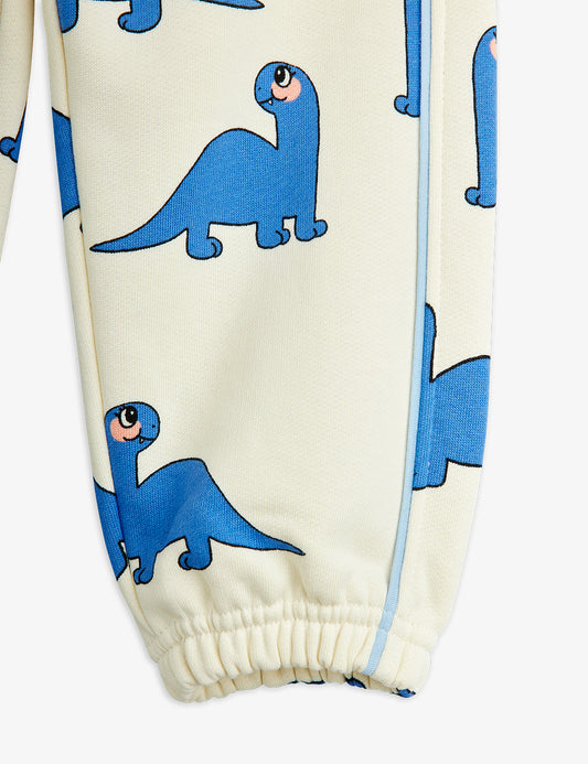 Children's pants with blue dinosaur pattern on a white background
