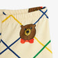 Beige shorts with a bear face and red bow tie on a white background