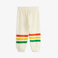 Cream-colored sweatpants with red, yellow, and green stripes on a white background