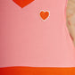 Pink dress with orange trim and heart design, featuring Mini Rodini branding.