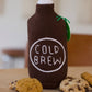 Knitted cold brew coffee bottle-shaped container with cookies on a wooden surface