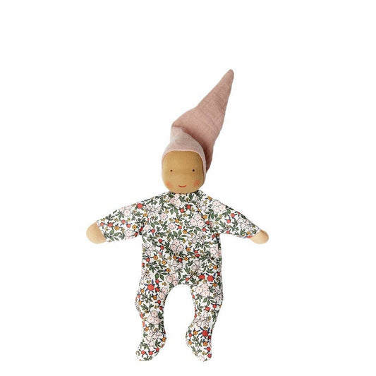 Fabric doll with floral onesie and pointed hat on a white background