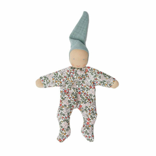 Baby doll with floral onesie and green hat on a white background