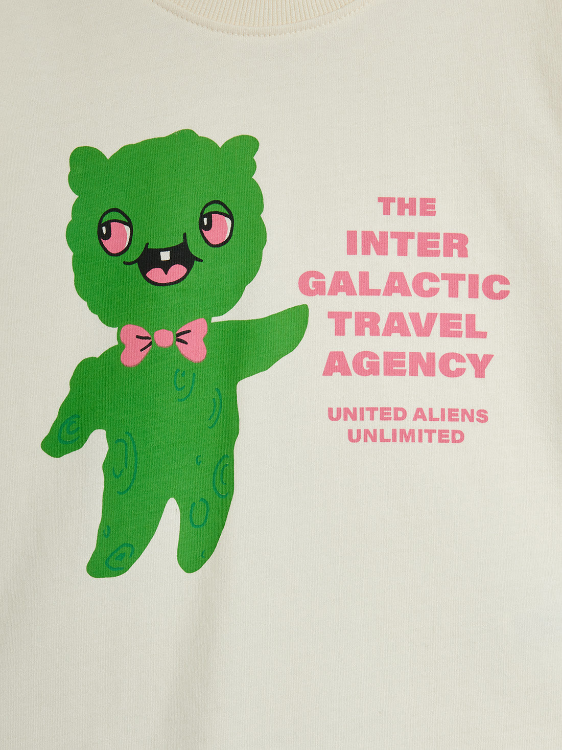 Green alien character with a bow tie and text 'The Inter Galactic Travel Agency' on a white background