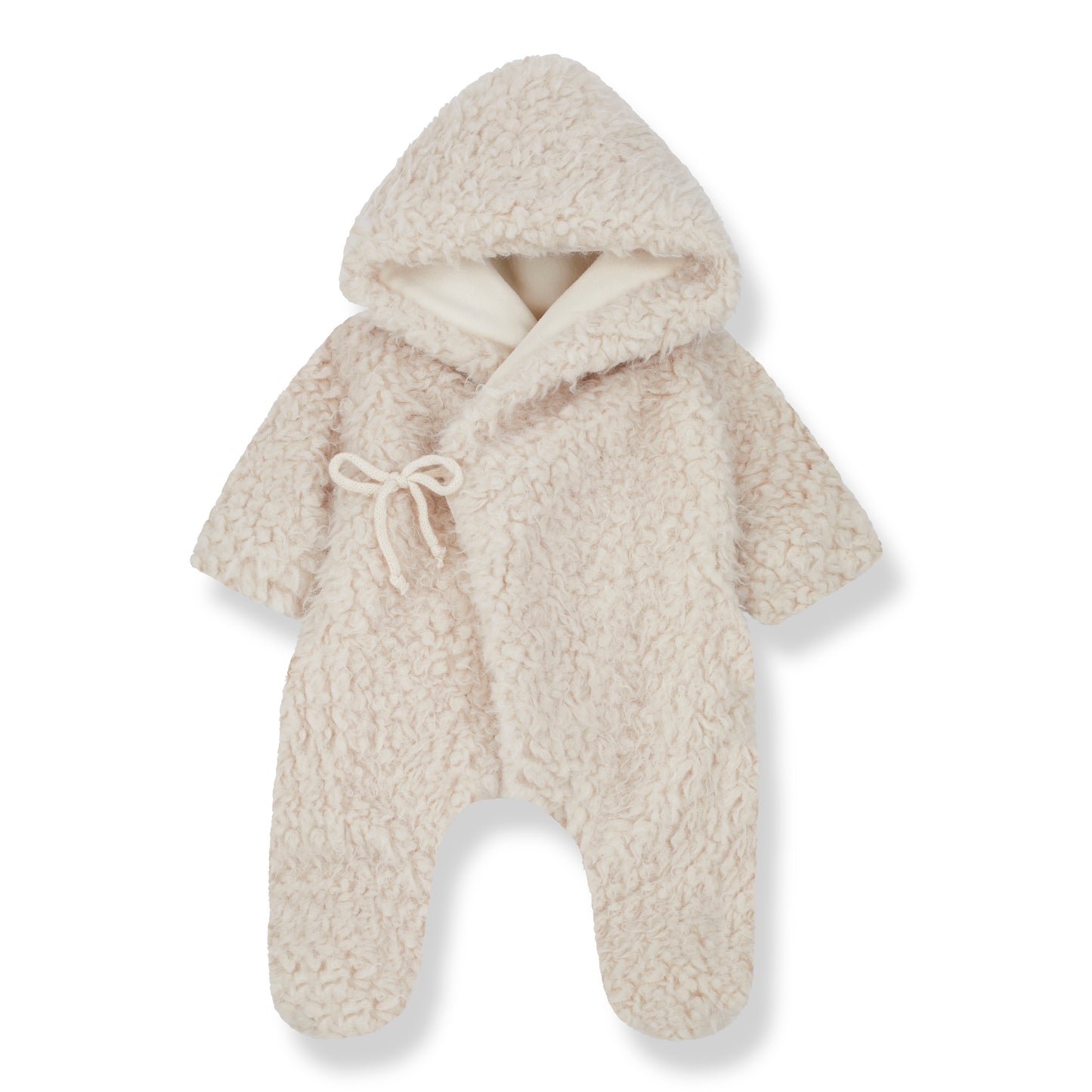 on a white backdrop, a fluffy fleece one piece jumpsuit. with covered feet and open hands, a little bow wrap over front and a hood, all in a creamy tone