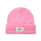 Pink beanie with a brand label on a white background