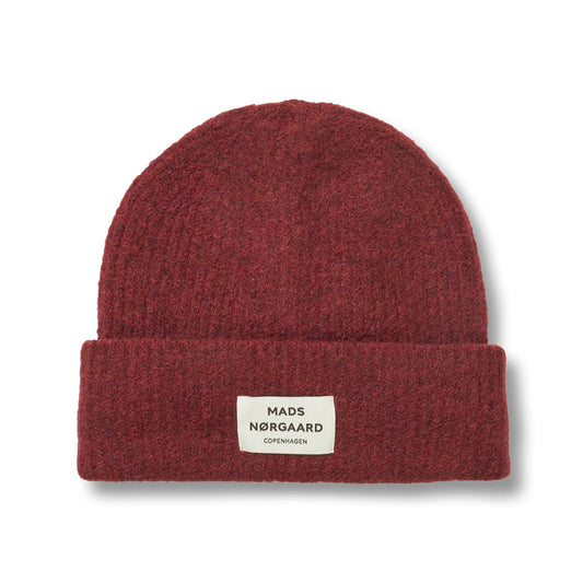 Red beanie with a brand label on a white background