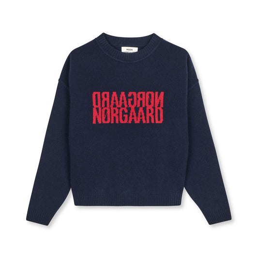 Navy sweater with red text on a white background