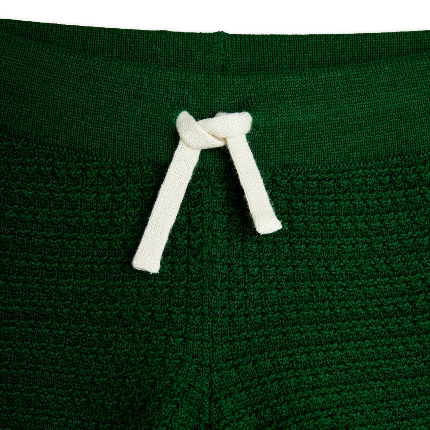 Detailed view of the Mini Rodini green knit shorts, showcasing the ribbed waistband with a white adjustable drawstring for a secure and comfortable fit.