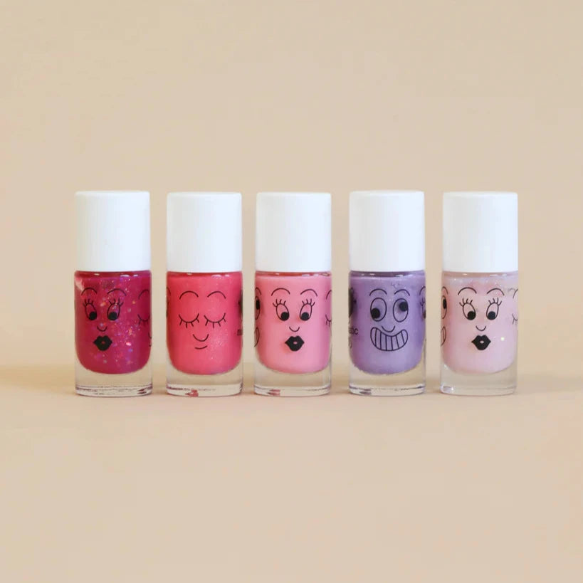 Five bottles of nail polish with cartoon faces on a beige background