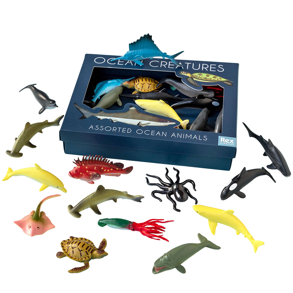 Assorted ocean animal toys in front of their packaging box labeled 'Ocean Creatures'.