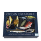 Box of assorted ocean animals toys with 'Ocean Creatures' text on a white background