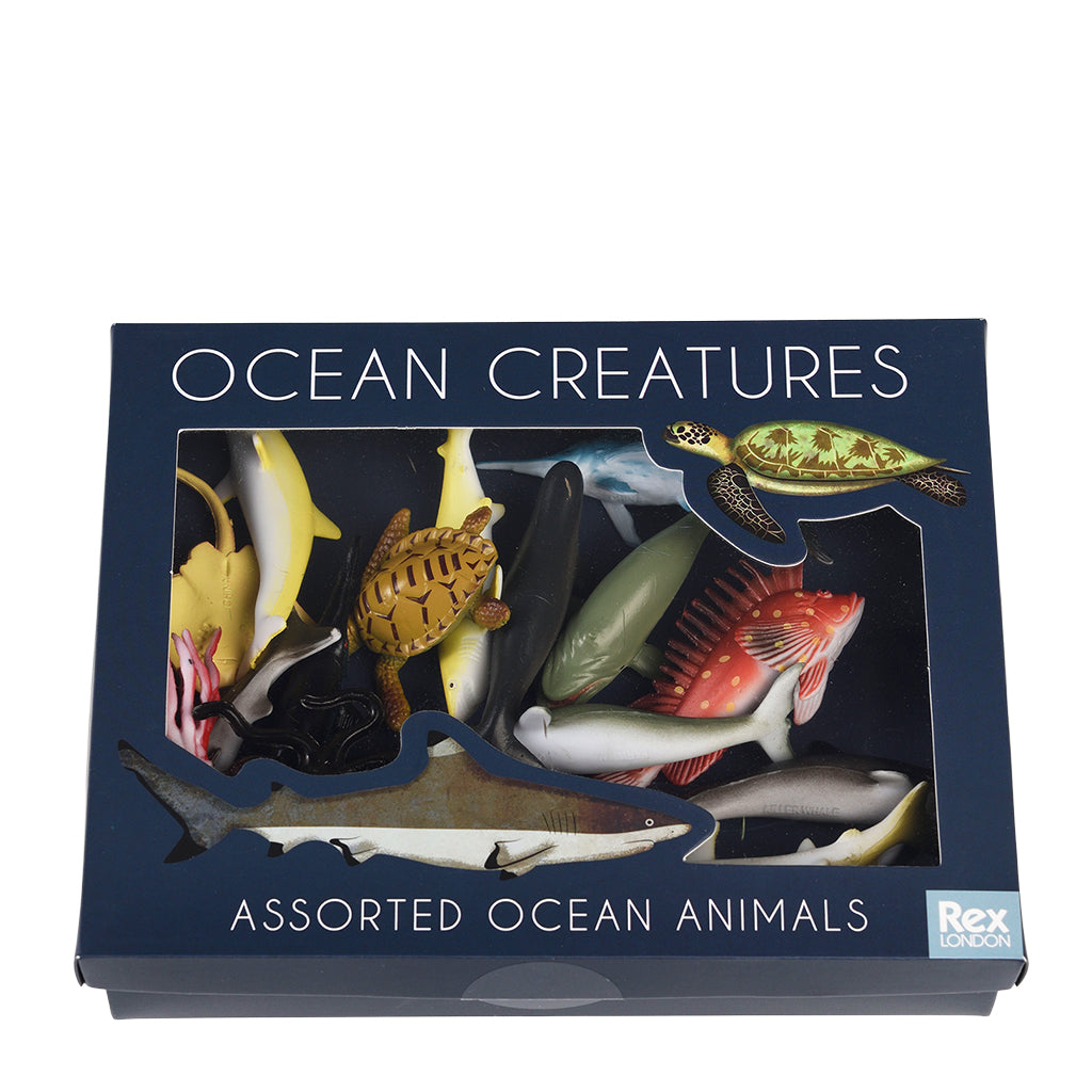 Box of assorted ocean animals toys with 'Ocean Creatures' text on a white background