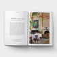 Open book showing a page with text and an image of a dining room.