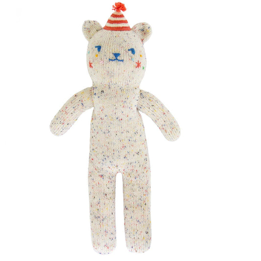 Knitted bear toy with colorful face and striped hat on a white background