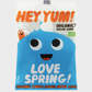 Packaged candy with blue character and 'Hey Yum!' branding on a white background