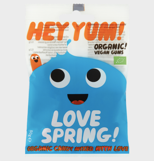 Packaged candy with blue character and 'Hey Yum!' branding on a white background