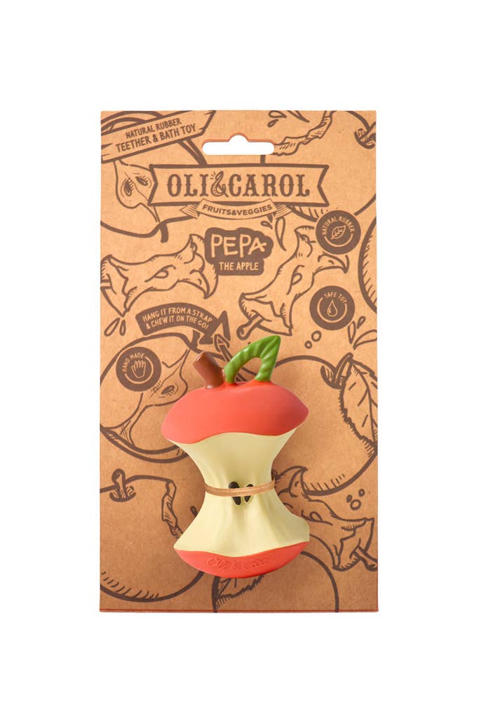 Oli & Carol dog toy packaging with a red and white apple-shaped toy on a brown background.