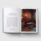 Open book with text and a photograph of a pub interior on a white background