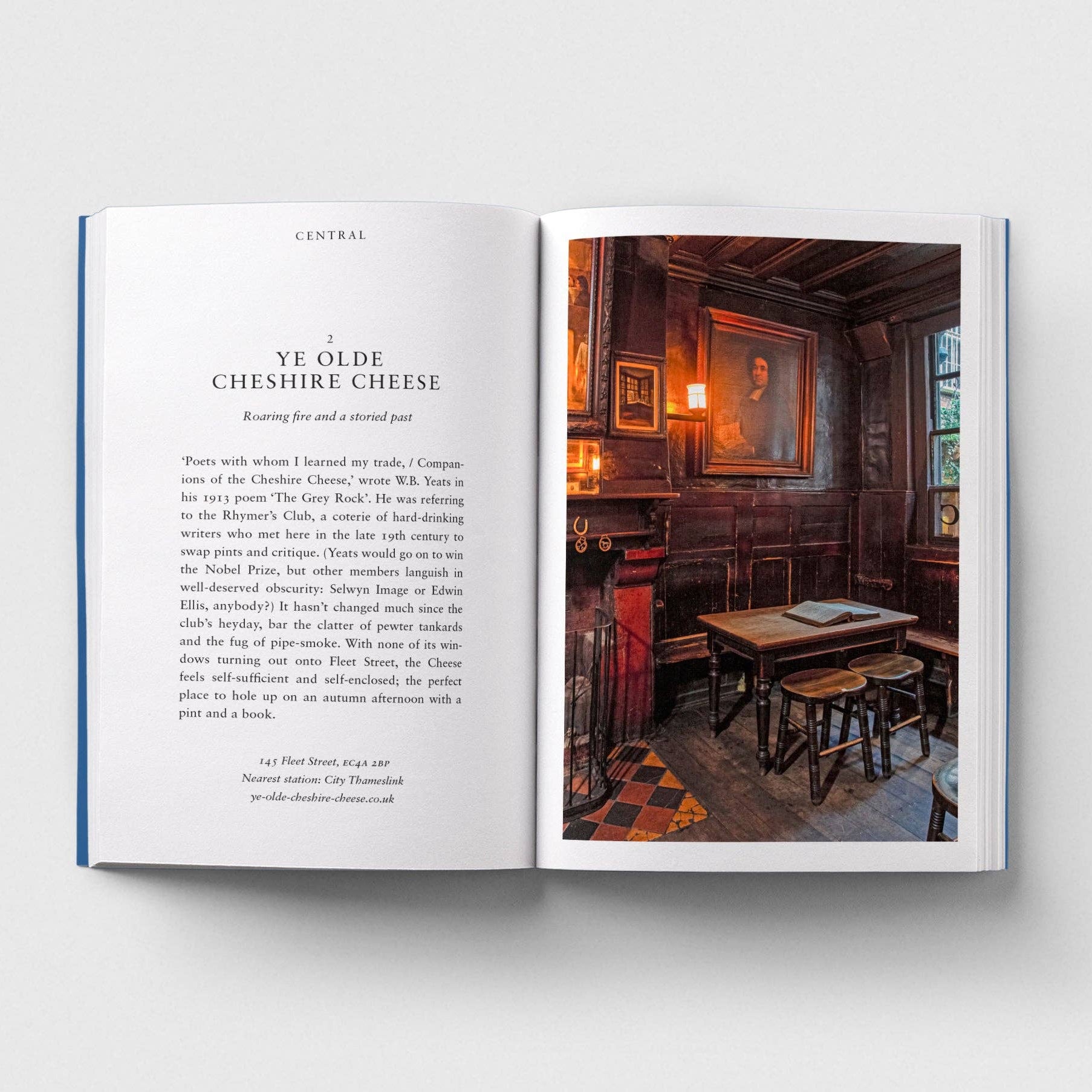 Open book with text and a photograph of a pub interior on a white background