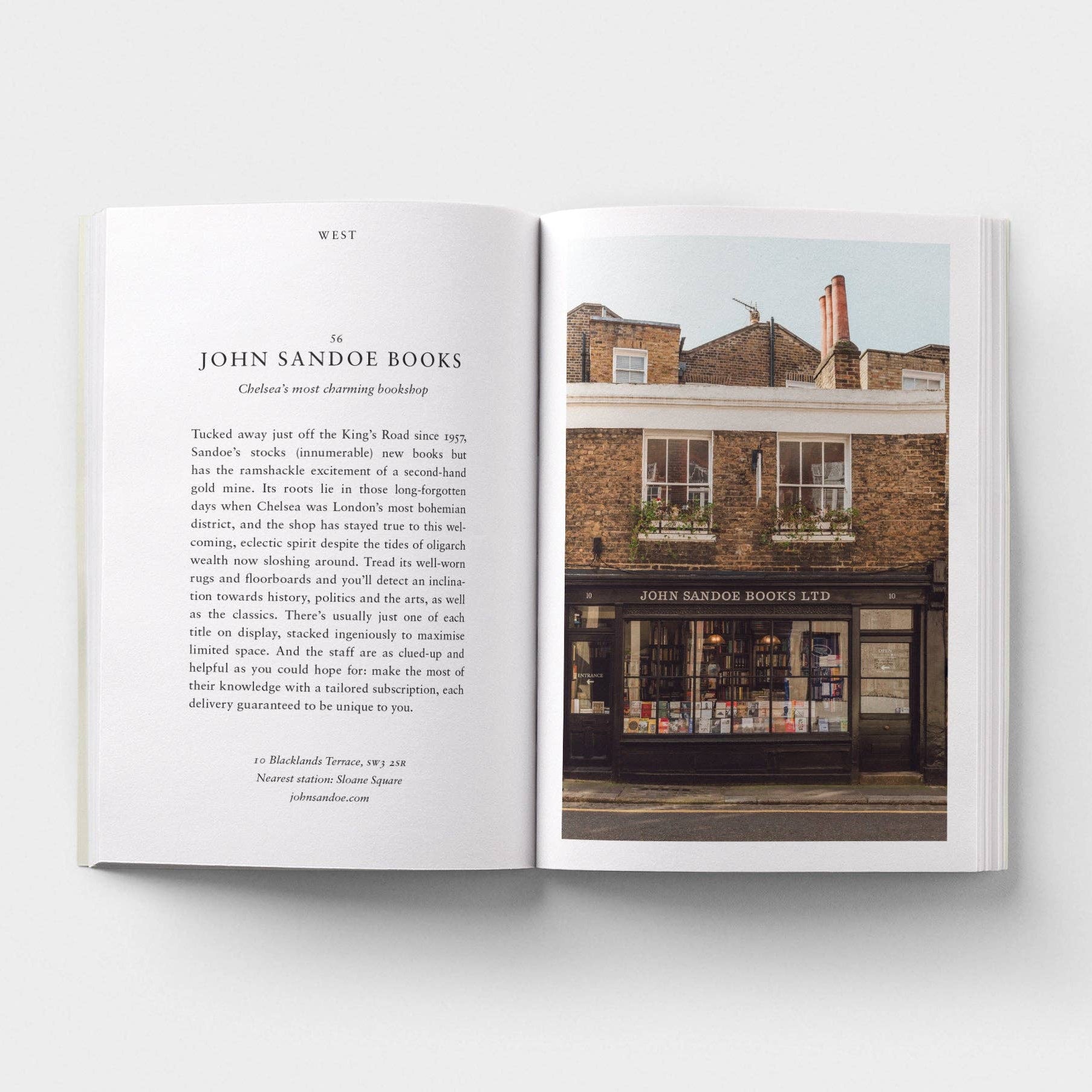 Open book showing text and a photograph of a building