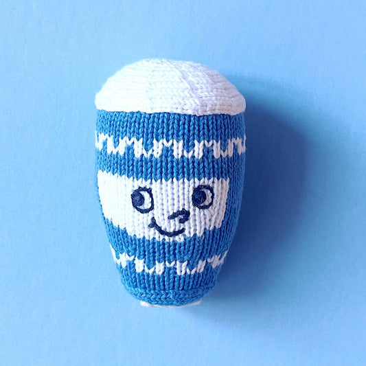 Blue and white knitted toy on a blue background