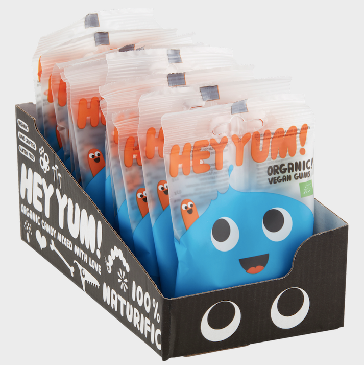 Display of HEY YUM! organic candy packages in a branded box.