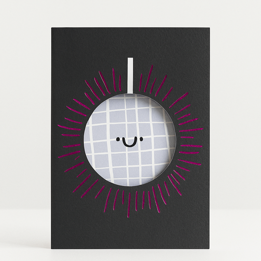 Framed picture of a smiley face with a checkered pattern on a black background