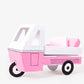 Pink toy camper with a white top on a white background