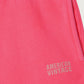 Close-up of the American Vintage Kids Fluorescent Hortensia Izubird Joggers, highlighting the subtle American Vintage logo on the leg and the soft cotton texture.