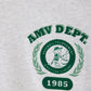 Close-up of the chest print on the American Vintage Kids Grey Gamipy T-Shirt, showcasing a green baseball tournament graphic with 'AMV DEPT.' text and '1985' detail