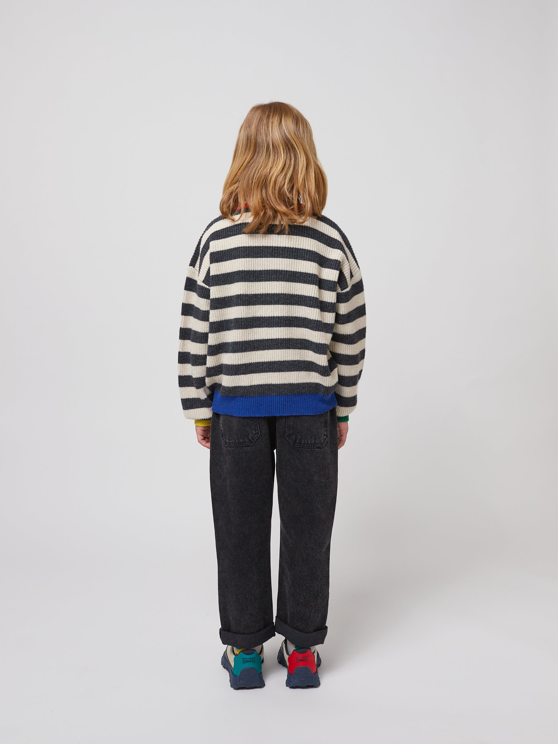 A back view of the model, showing the patch pockets and the slightly cropped length with a rolled-up hem.