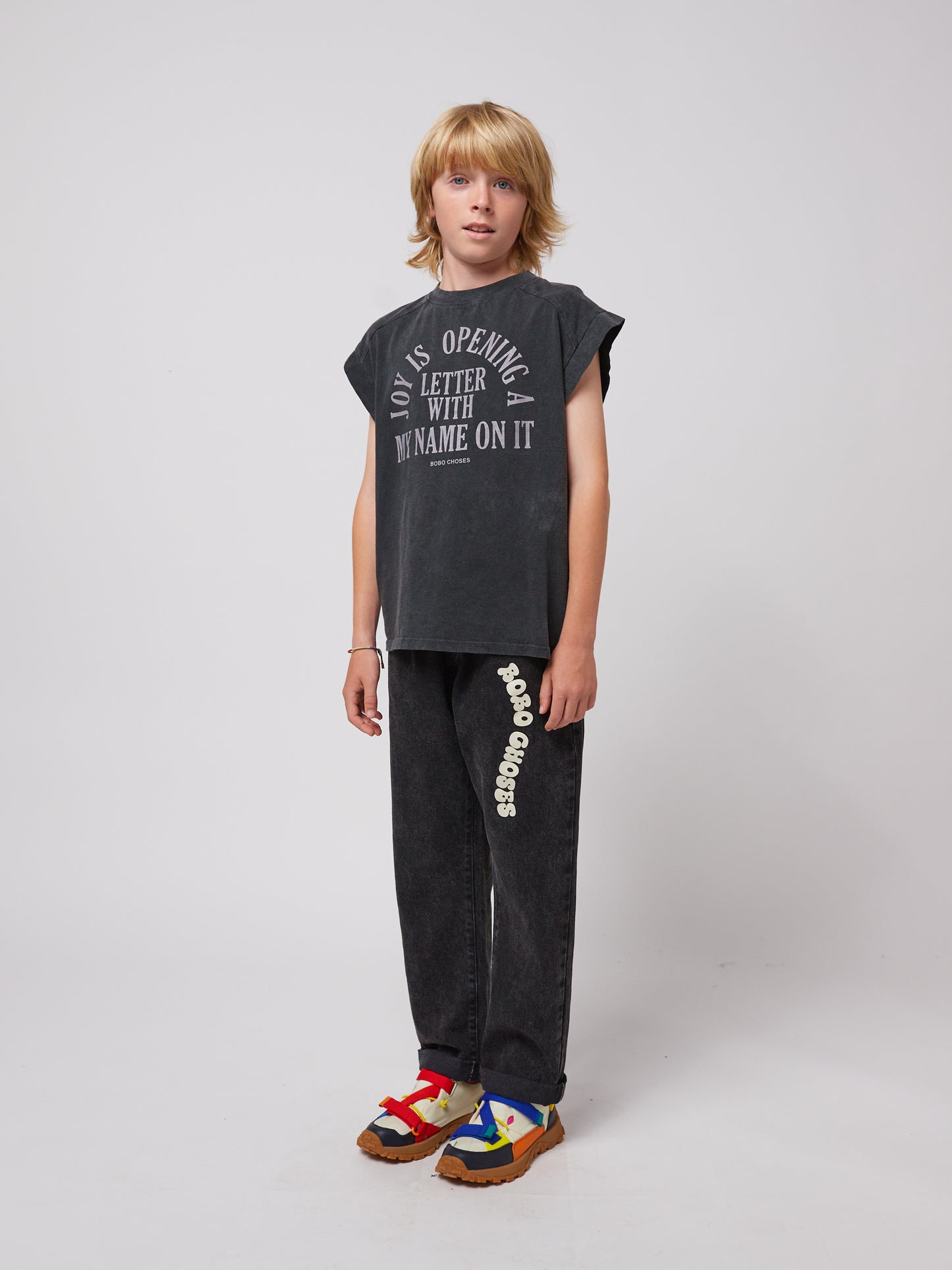 A side view of the same outfit, showing the "Bobo Choses" logo on the left leg and the slightly rolled-up cuffs for a casual look.