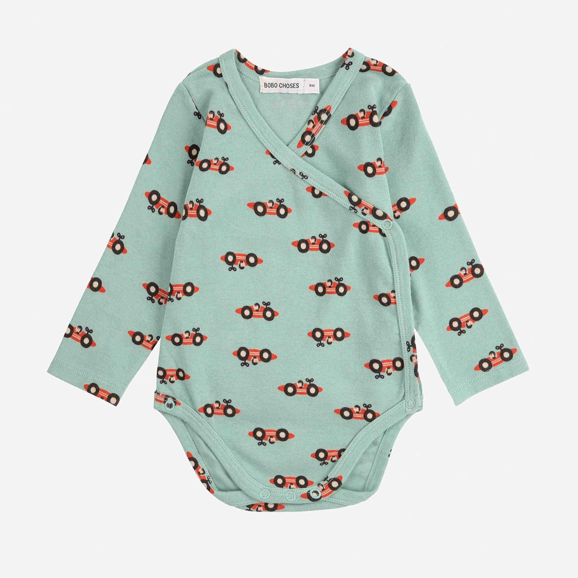 Light green baby onesie with red car pattern on a white background