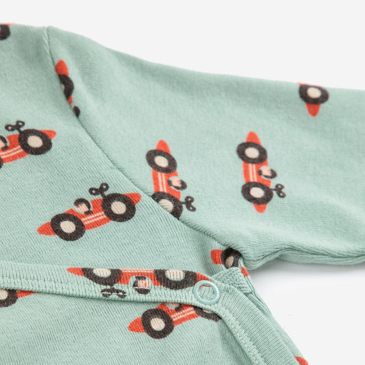 Light green fabric with red and blackrace car pattern on a white background