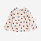 White shirt with colourful geometric pattern on a white background