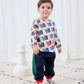 Child wearing a patterned shirt and dark pants on a white background