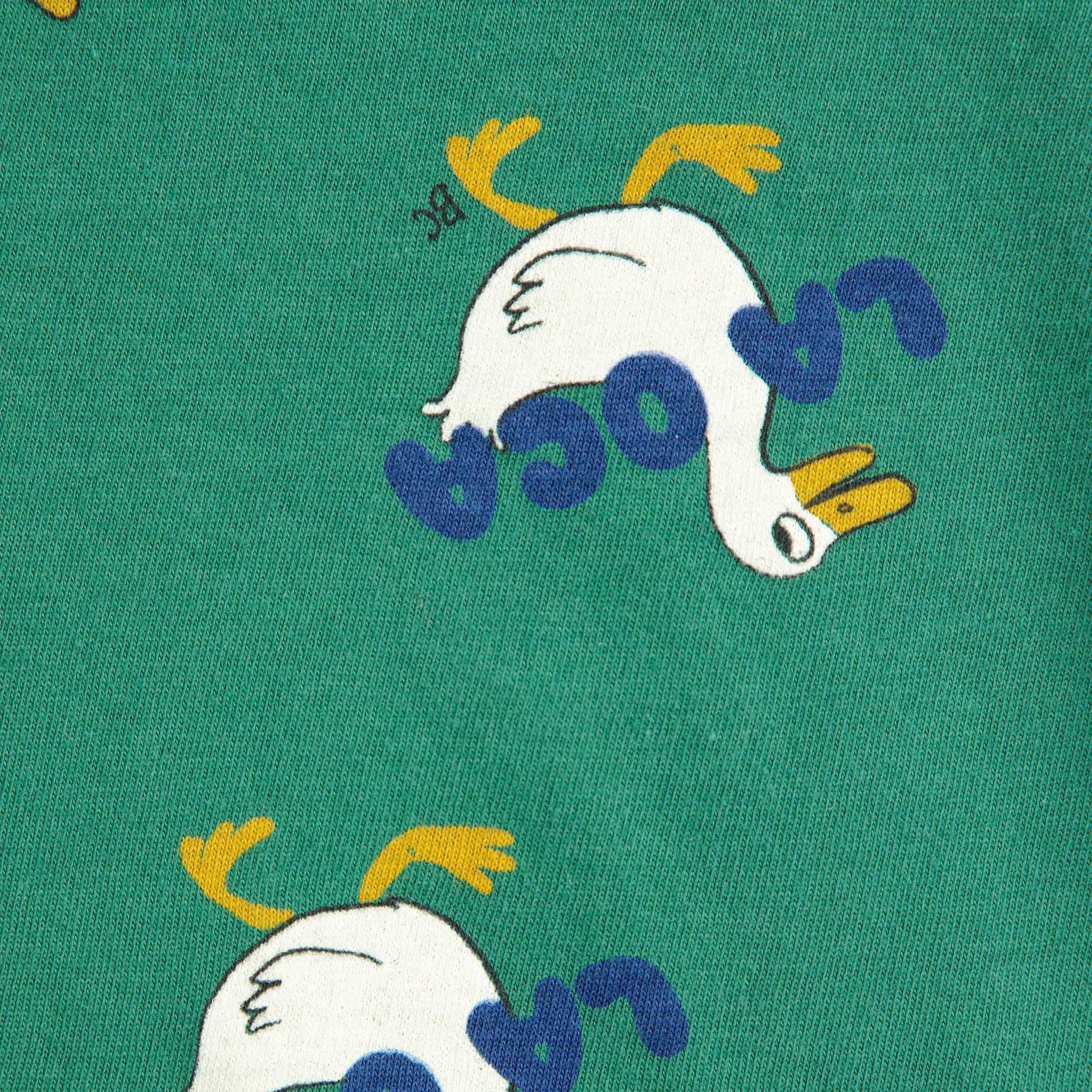 Green fabric with cartoon duck design and 'Loro' text