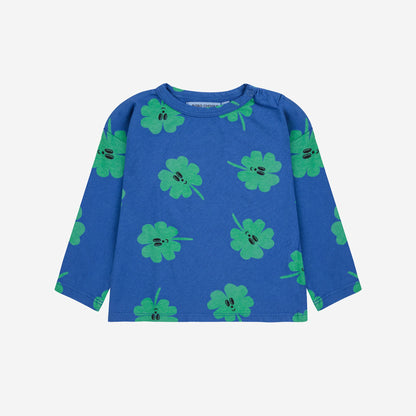 Blue long-sleeve shirt with green clover pattern on a white background
