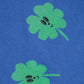 Two green four-leaf clover designs on a blue background