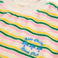 Striped sweater with colorful text and graphics on a beige background